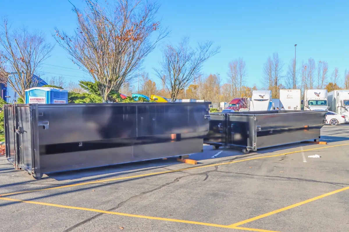 Professional dumpster rental service with roll-off container on residential driveway in North Alamo